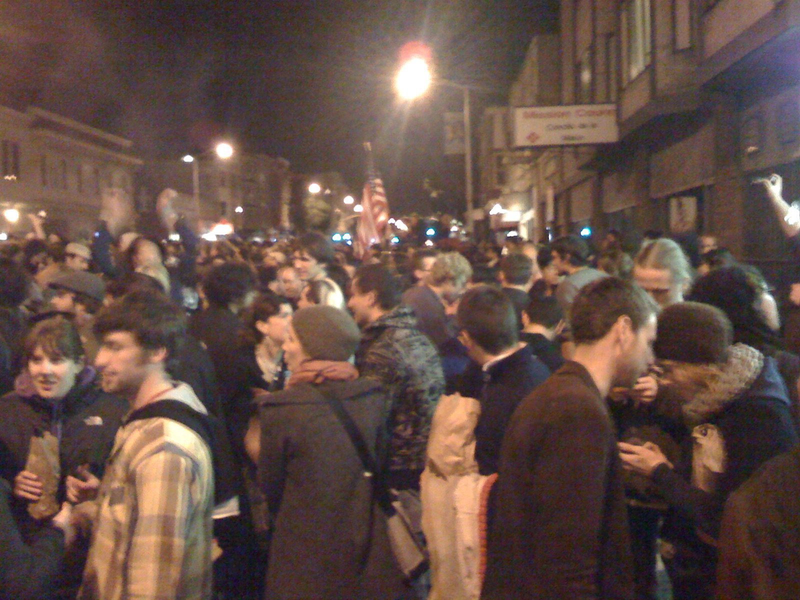 Stars and Stripes being paraded through the crowds on Valencia Street.
